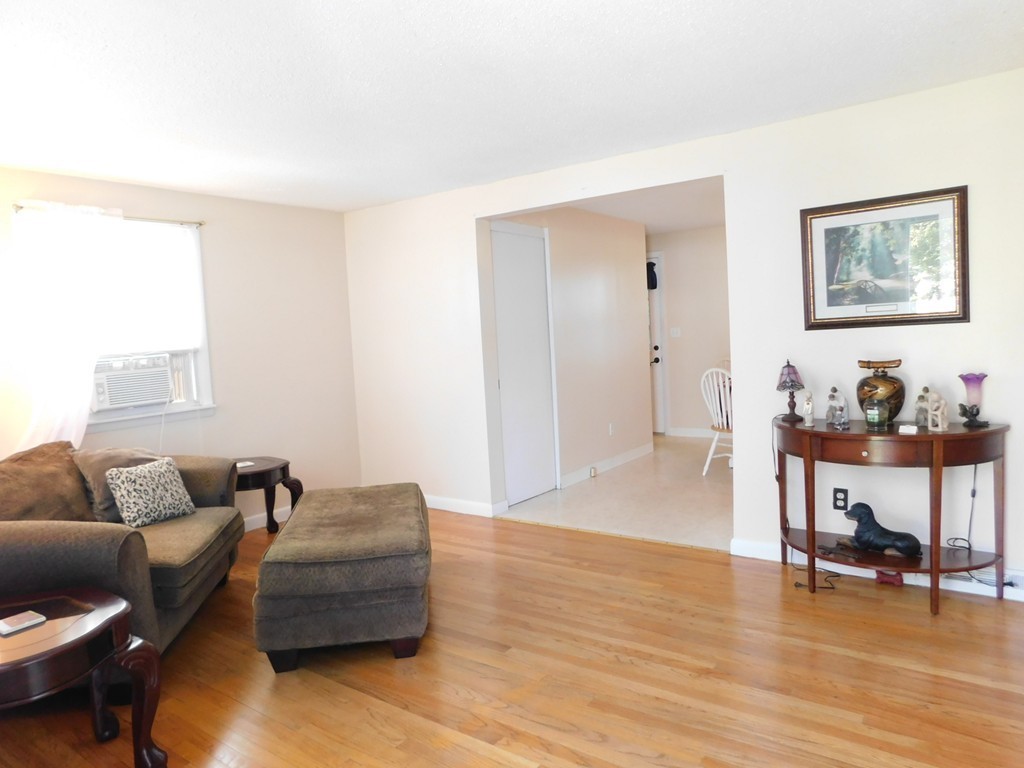 96 Laurence Street Springfield, MA 01104 - Photo 3 of 21 a living room with furniture and a wooden floor