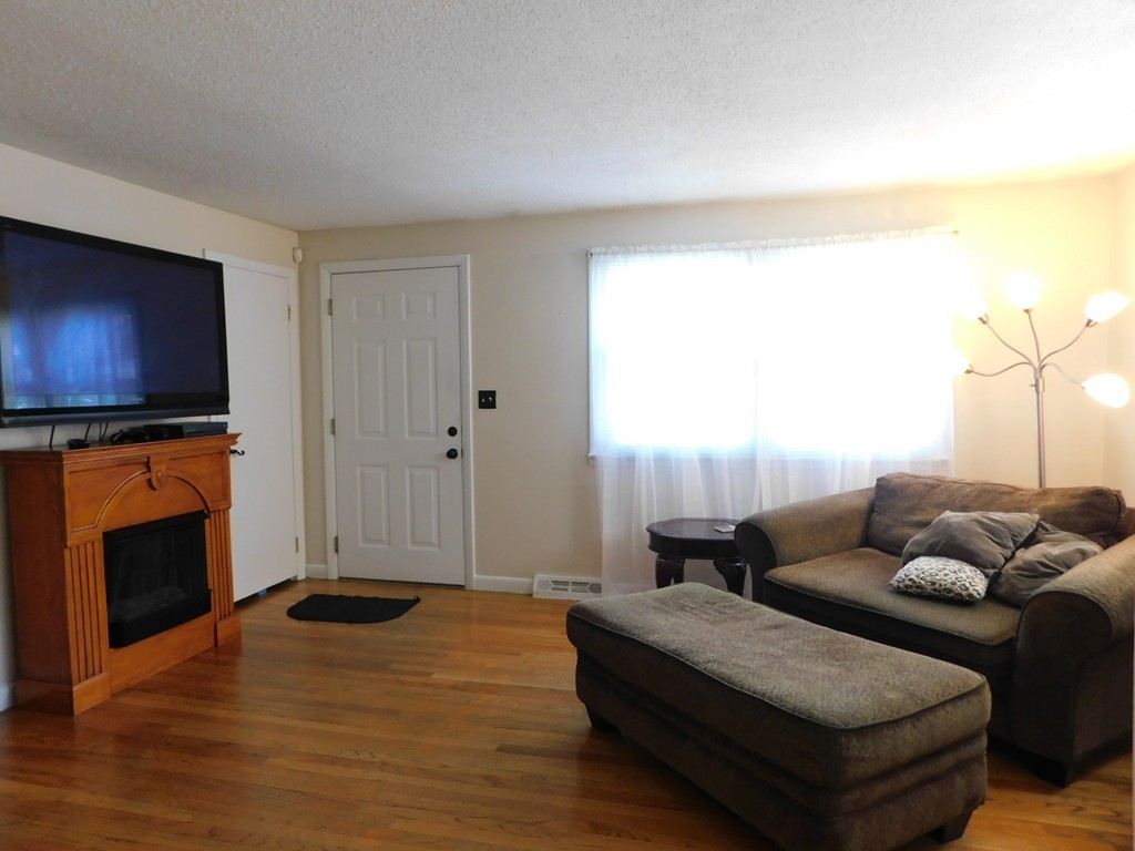 96 Laurence Street Springfield, MA 01104 - Photo 4 of 21 a living room with furniture and a flat screen tv