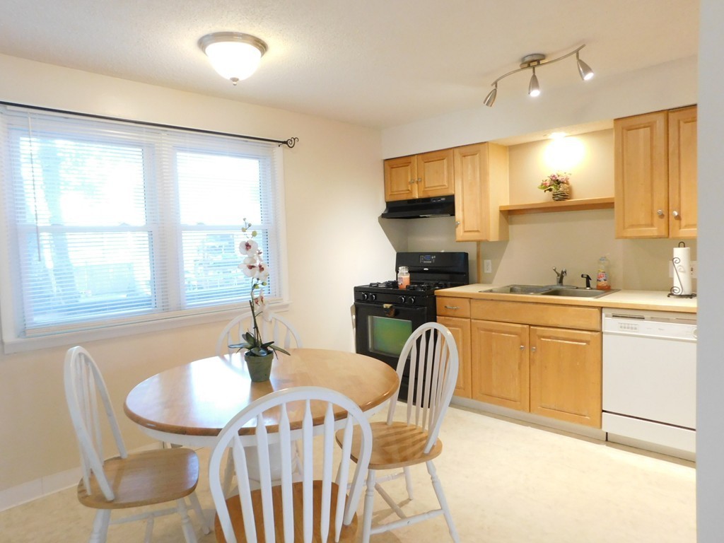 96 Laurence Street Springfield, MA 01104 - Photo 5 of 21 a dining room with furniture a window and kitchen view
