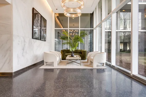 a dining room with furniture a chandelier and wooden floor