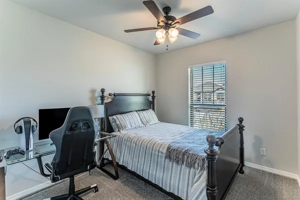 a bedroom with a bed and chair