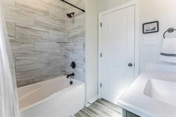 a bathroom with a tub and a shower