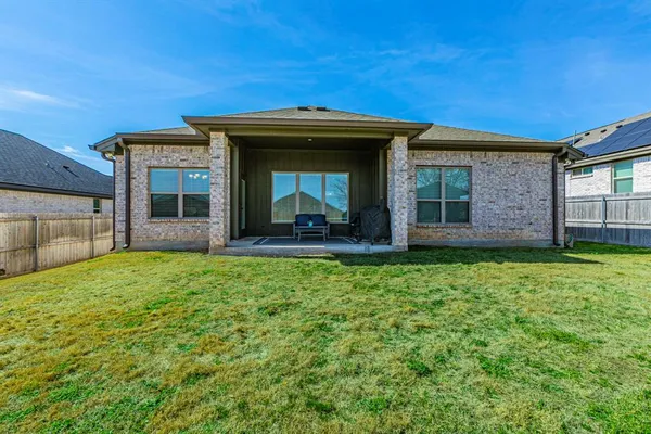 a view of a backyard with a garden and entertaining space