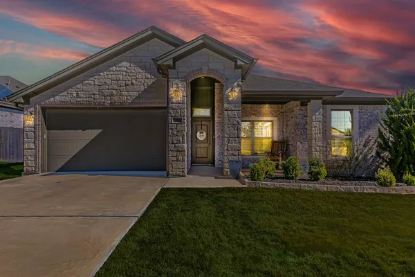 a front view of a house with a yard