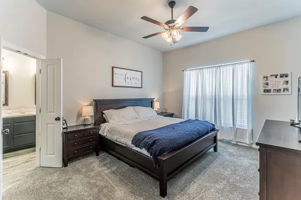 a bedroom with a bed and a chandelier
