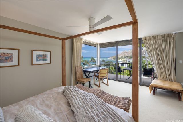 a bedroom with a bed and a balcony