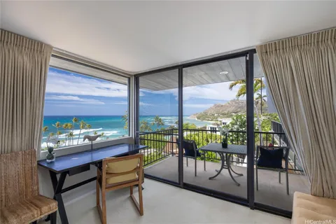 a living room with furniture and a floor to ceiling window