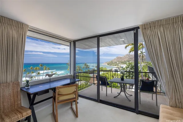 a living room with furniture and a floor to ceiling window