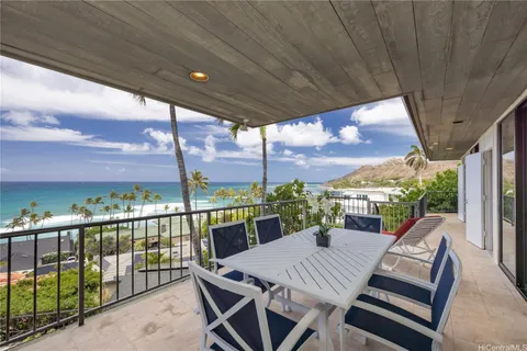 a view of a patio with a table chairs and a glass door