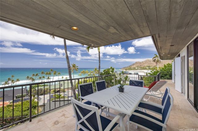 a view of a patio with a table chairs and a glass door
