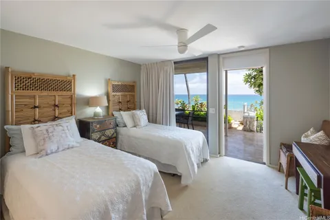 a bedroom with two beds and a window