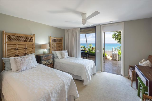 a bedroom with two beds and a window