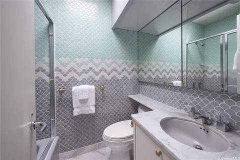 a bathroom with a sink toilet and shower