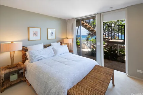 a spacious bedroom with a bed and a large window