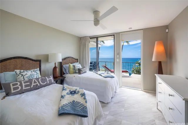 a bedroom with furniture and a large window