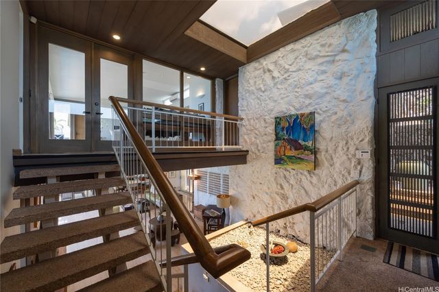 a view of entryway with wooden floor and stairs