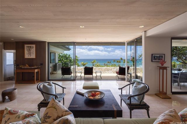 a living room with furniture and a floor to ceiling window