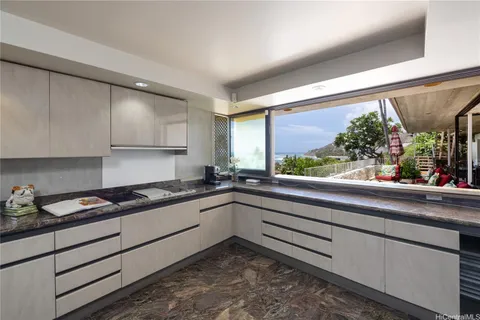 a kitchen with granite countertop sink and cabinets