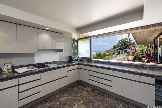 a kitchen with granite countertop sink and cabinets