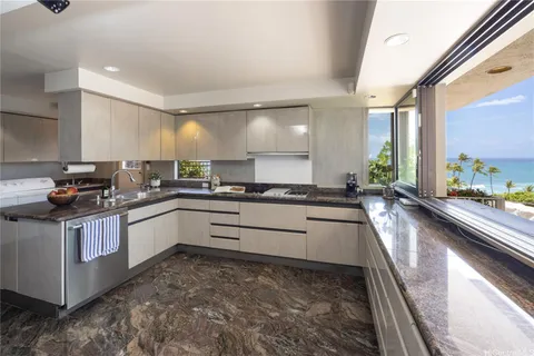 a kitchen with stainless steel appliances granite countertop a lot of counter space and a sink