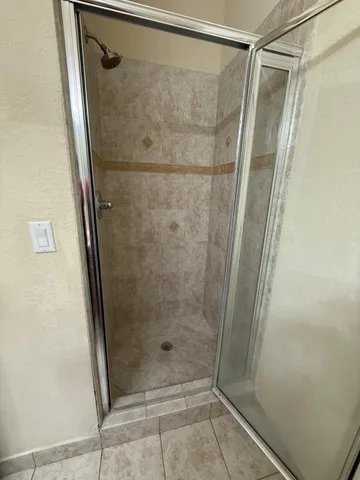 a bathroom with a glass door shower