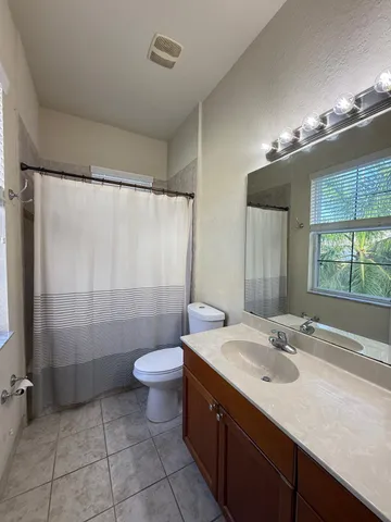 a bathroom with a sink toilet double vanity and shower