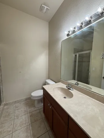 a bathroom with a sink a toilet and mirror