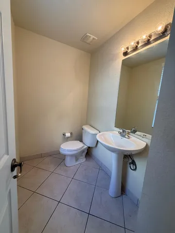 a bathroom with a sink a toilet and mirror