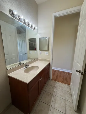 a bathroom with a sink vanity and a mirror