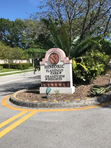 a wooden bench sitting in the middle of a park