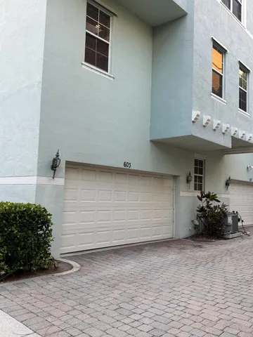 a front view of a house with parking space