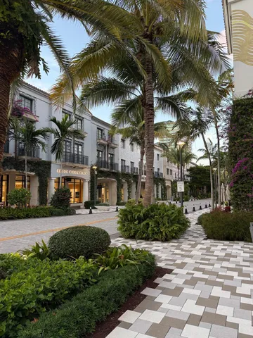 a view of a street with a building and trees in the background