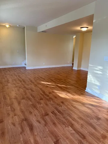 a view of a room with wooden floor and staircase