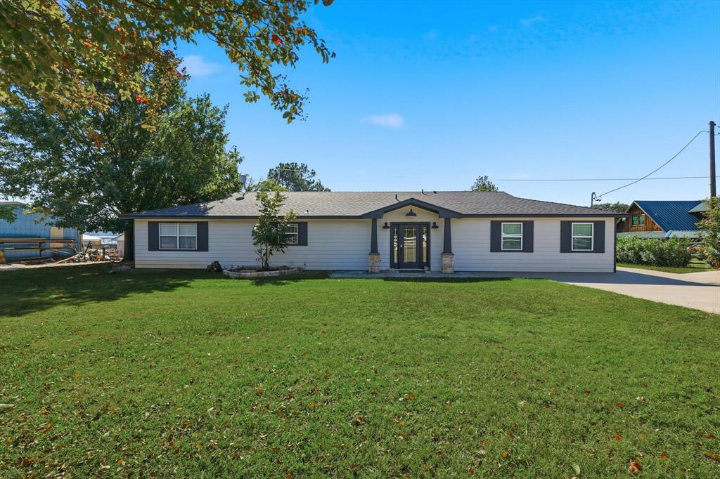 4433 Chapel Road Graham, TX 76450 - Photo 13 of 32 a front view of a house with a garden