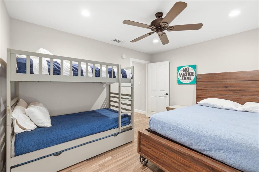 4433 Chapel Road Graham, TX 76450 - Photo 23 of 32 a bedroom with a bed and a chandelier