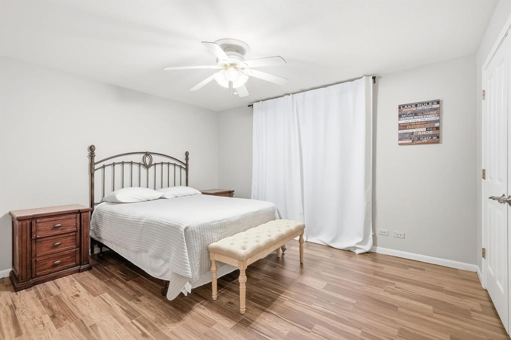 4433 Chapel Road Graham, TX 76450 - Photo 25 of 32 a bedroom with a bed and a chandelier