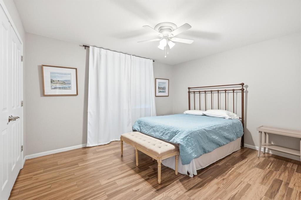 4433 Chapel Road Graham, TX 76450 - Photo 27 of 32 a bedroom with a bed and a chandelier