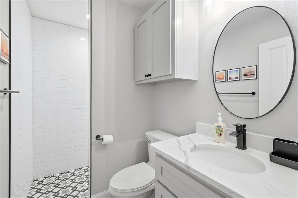 4433 Chapel Road Graham, TX 76450 - Photo 28 of 32 a bathroom with a sink a toilet and a mirror