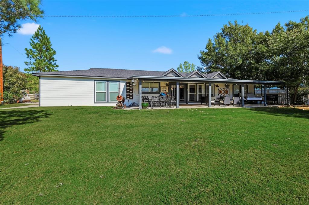 4433 Chapel Road Graham, TX 76450 - Photo 10 of 32 a view of a house with a big yard and large trees