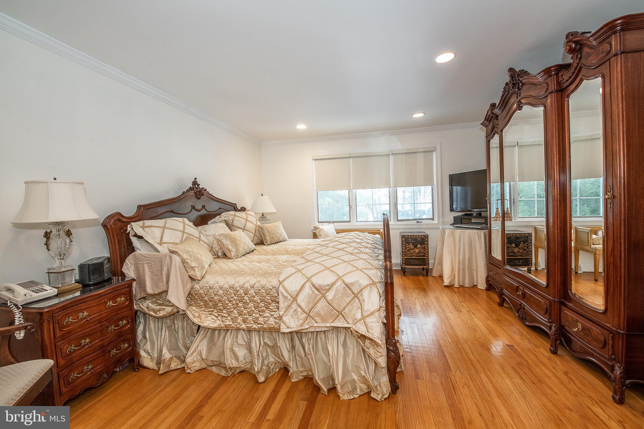 2209 North Stone Ridge Lane Villanova, PA 19085 - Photo 15 of 29 a large bedroom with a bed and wooden floor