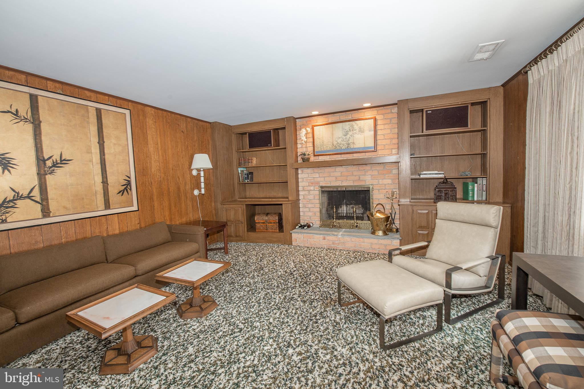 2209 North Stone Ridge Lane Villanova, PA 19085 - Photo 20 of 29 a living room with furniture a fireplace and a floor to ceiling window