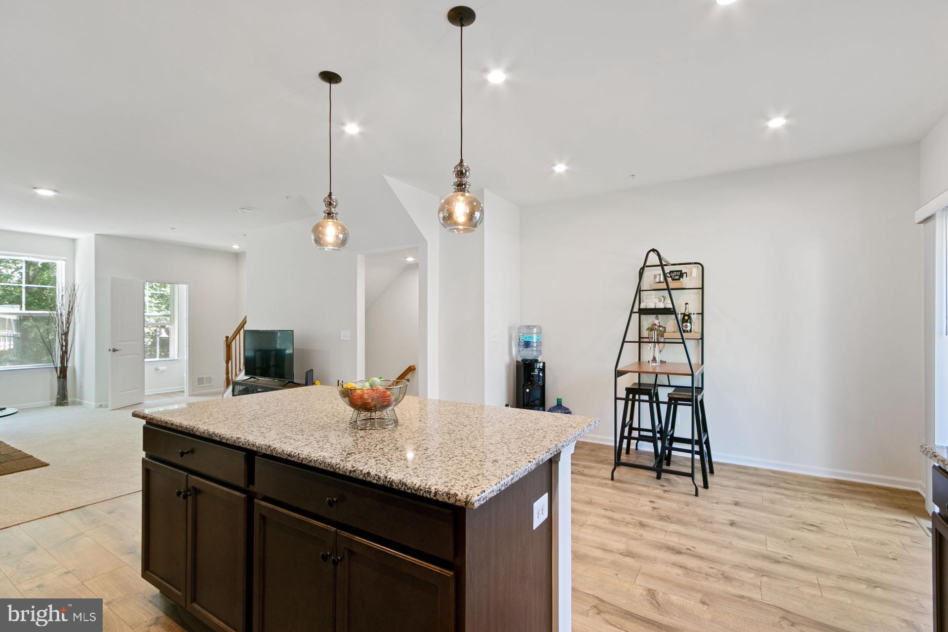 340 Shipyard Drive Cambridge, MD 21613 - Photo 18 of 35 a kitchen with a sink a center island and wooden floor