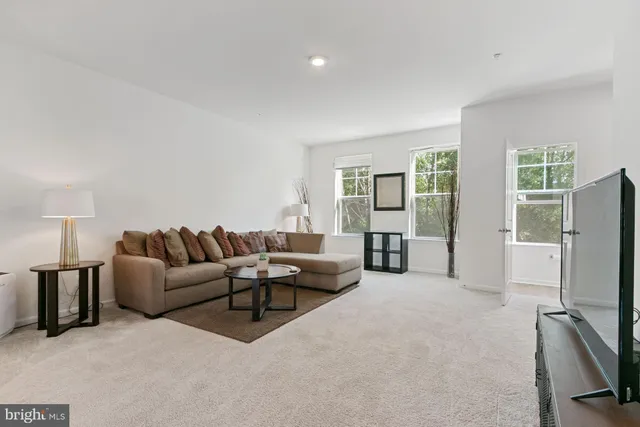 a living room with furniture window and a flat screen tv