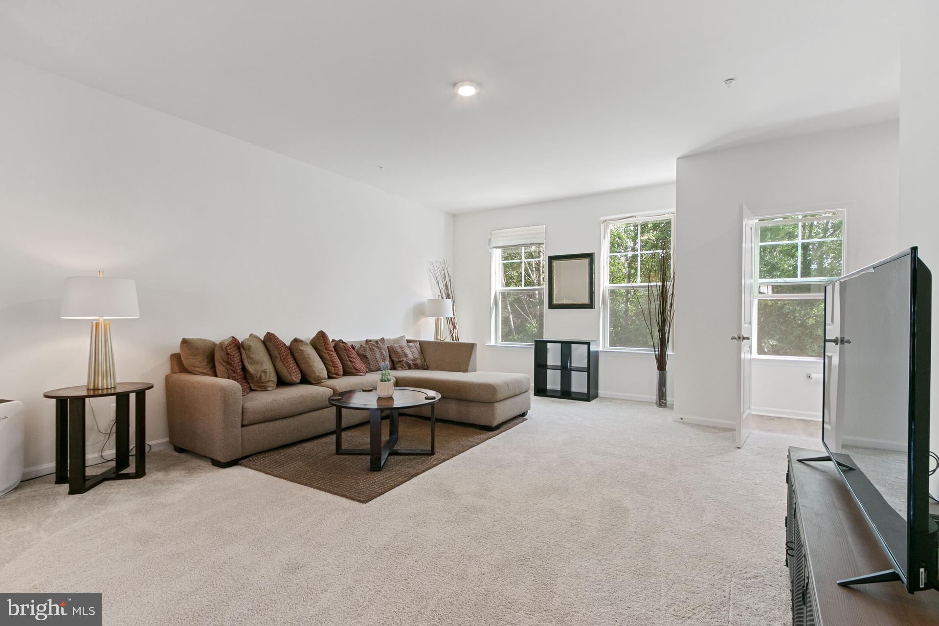 340 Shipyard Drive Cambridge, MD 21613 - Photo 20 of 35 a living room with furniture window and a flat screen tv
