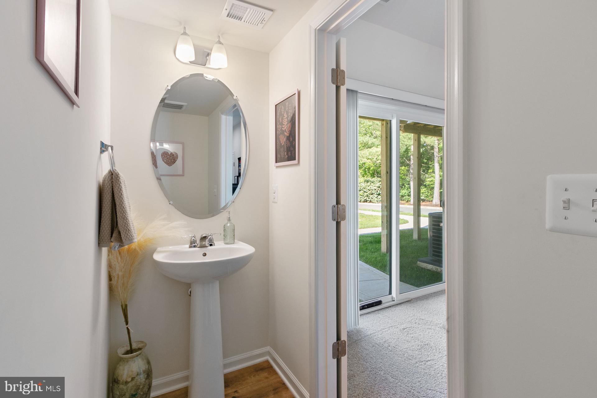 340 Shipyard Drive Cambridge, MD 21613 - Photo 7 of 35 a view of a bathroom with a sink mirror and window