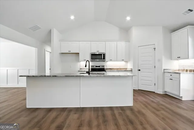 a view of kitchen with refrigerator and window
