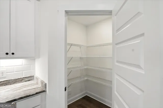 a kitchen with stainless steel appliances granite countertop a stove top oven a sink a counter space and cabinets