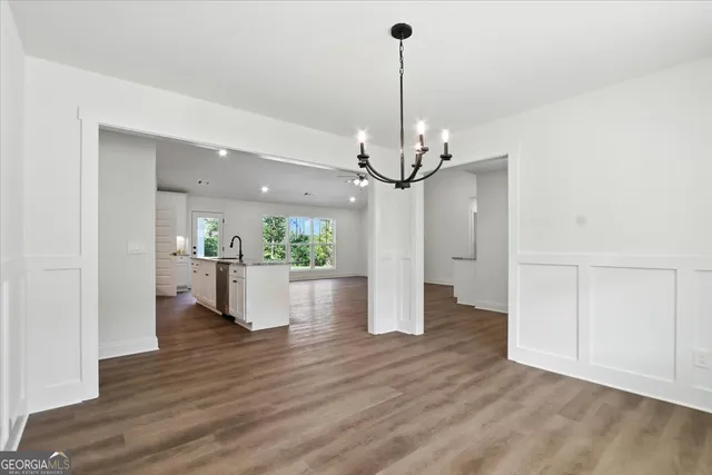 a view of a living room and kitchen with furniture