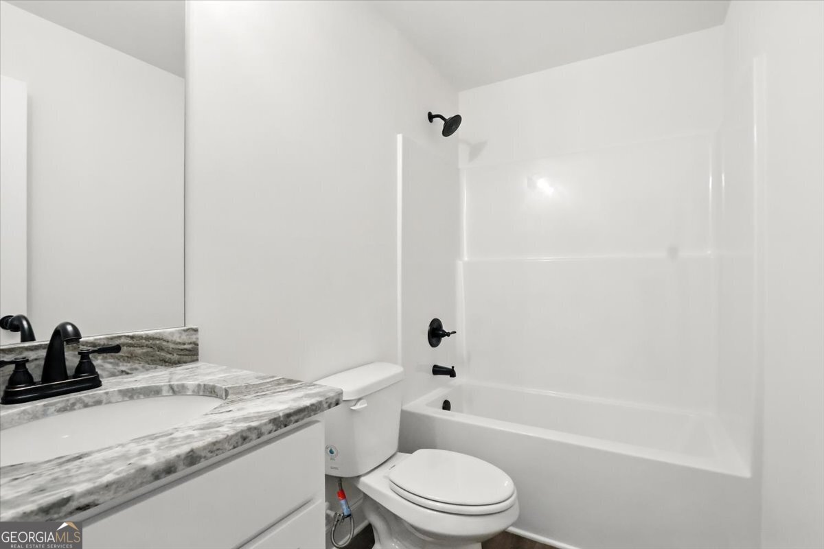 166 Rachel Lane Hartwell, GA 30643 - Photo 27 of 51 a bathroom with a granite countertop toilet a sink and a bathtub