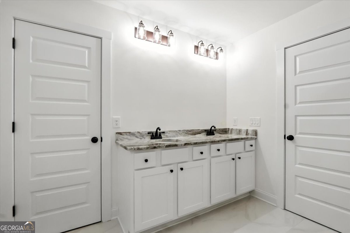 166 Rachel Lane Hartwell, GA 30643 - Photo 35 of 51 a bathroom with a granite countertop sink and a mirror